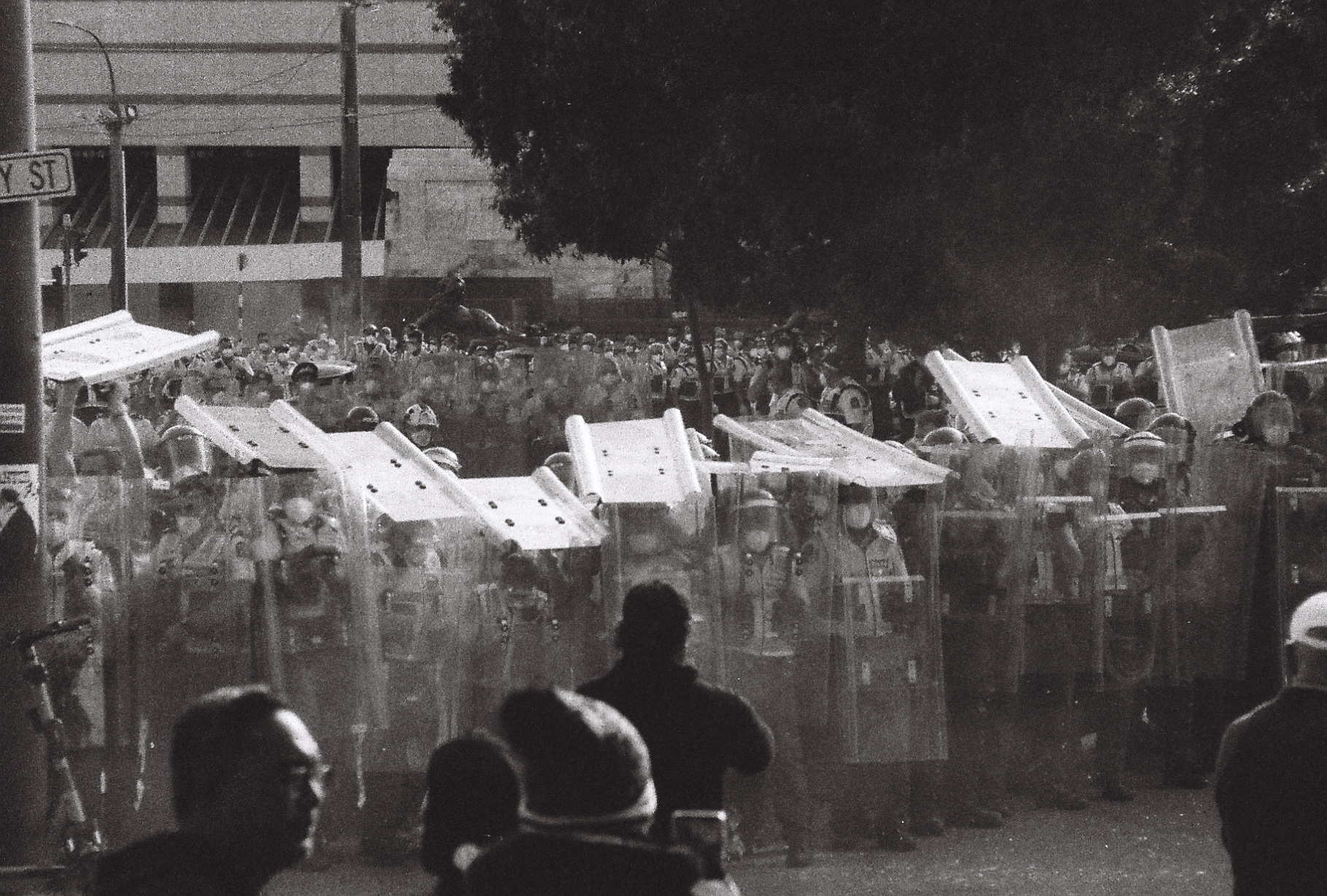 black and whtie image of riot police forming a line